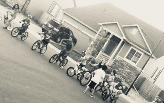 kids riding on bikes in the neighborhood